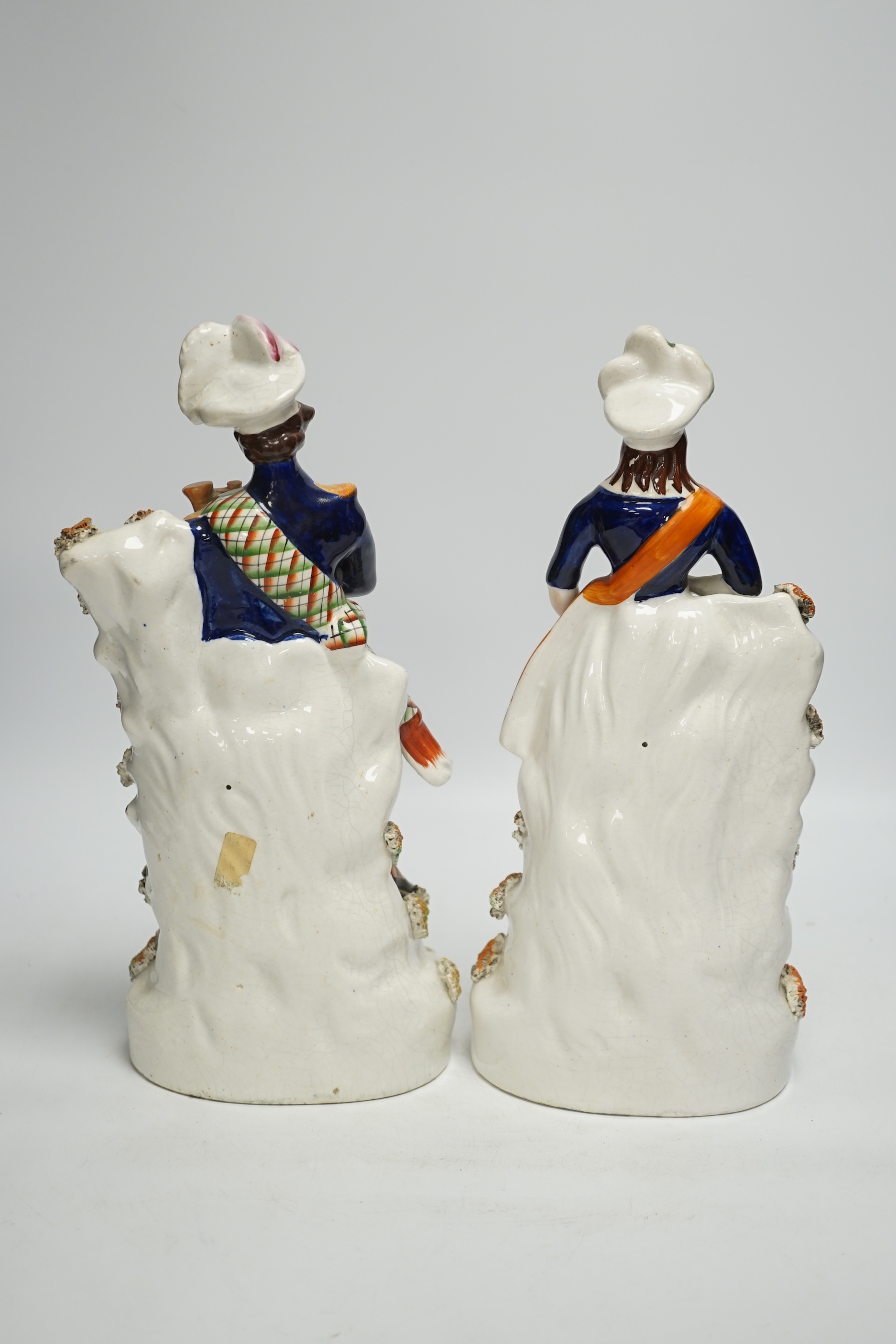 A pair of Victorian Staffordshire figures of Scots musicians